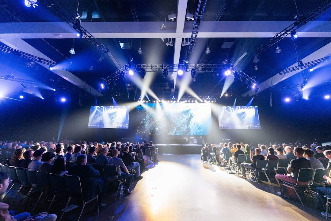Technology conference with large audience and presentation screen